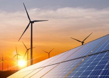 Wind,Turbine,With,Solar,Panels,And,Sunset.,Concept,Clean,Energy.